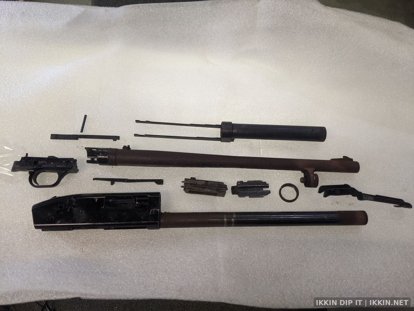 Rusted and pitted shotgun before restoration